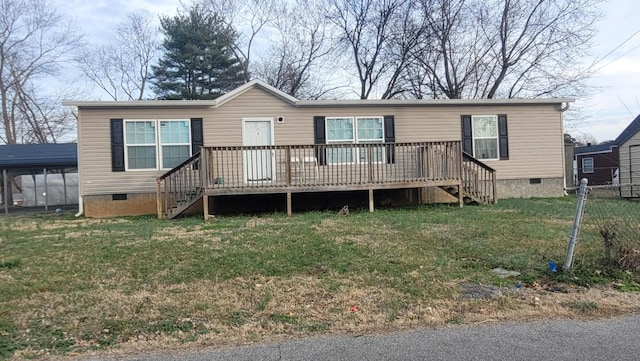 back of house with a wooden deck and a yard