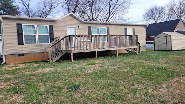 rear view of house featuring a wooden deck, a lawn, and a storage unit