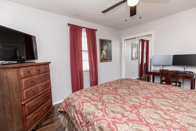 bedroom with dark hardwood / wood-style flooring, a closet, and ceiling fan