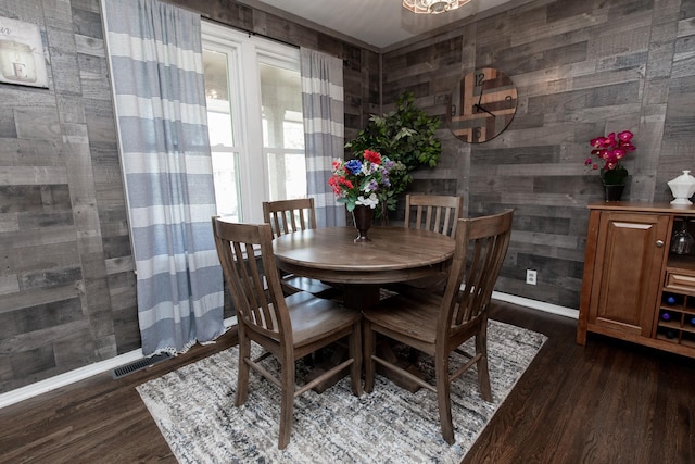 dining space featuring dark wood-type flooring