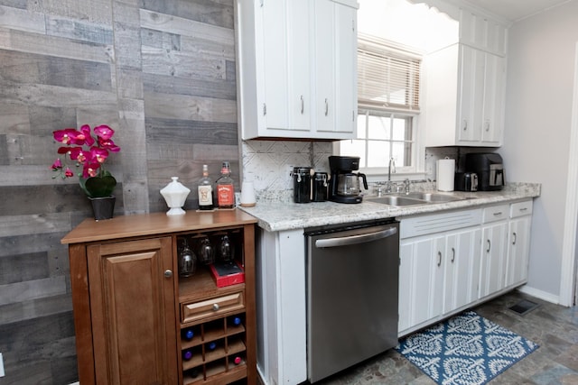 kitchen featuring white cabinetry, sink, backsplash, and stainless steel dishwasher