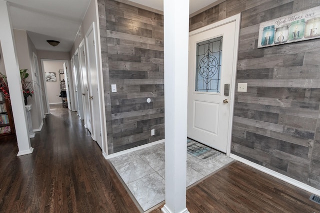 interior space featuring dark hardwood / wood-style flooring and wood walls