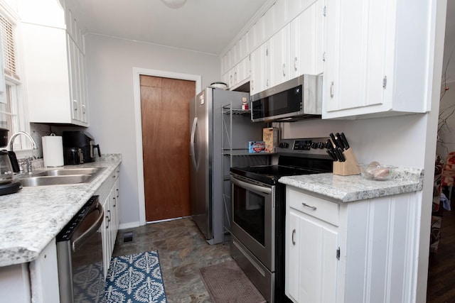 kitchen featuring appliances with stainless steel finishes, sink, and white cabinets