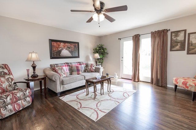 living room with dark wood-type flooring and ceiling fan