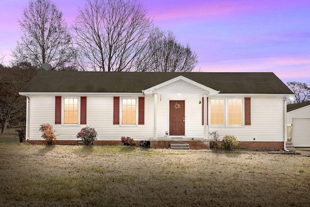 single story home featuring a garage and a yard