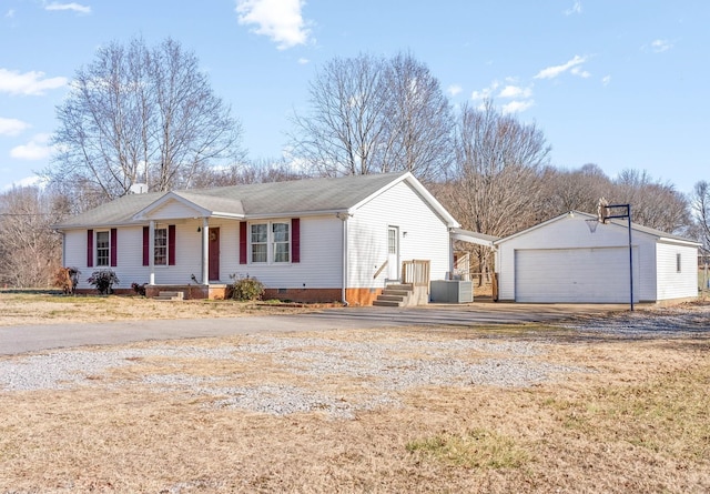 single story home featuring a garage, an outdoor structure, and central AC unit