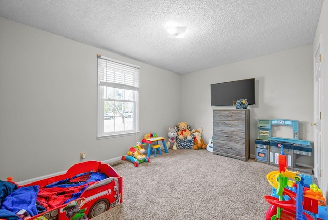 recreation room featuring carpet flooring and a textured ceiling