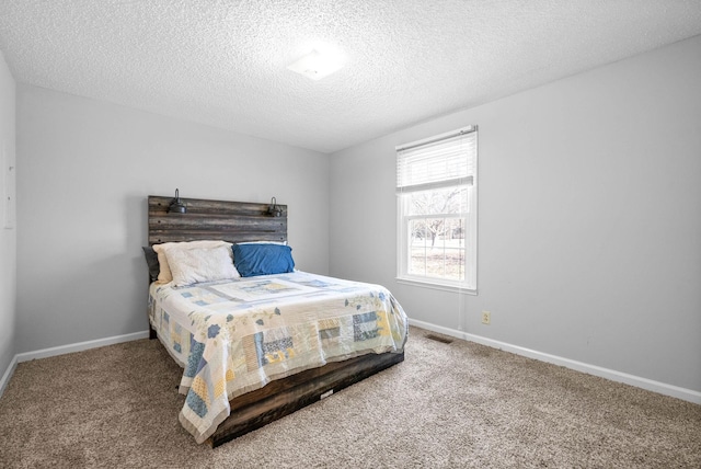 carpeted bedroom featuring a textured ceiling