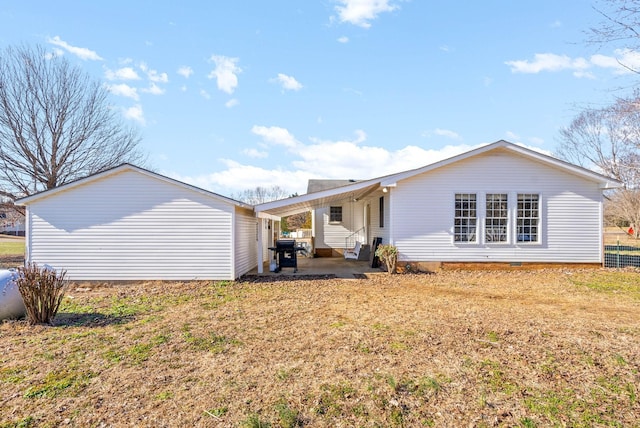 back of property featuring a yard and a patio area