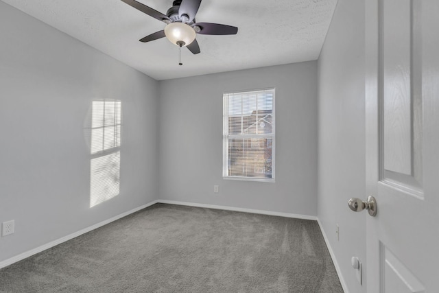 carpeted empty room featuring ceiling fan and a textured ceiling