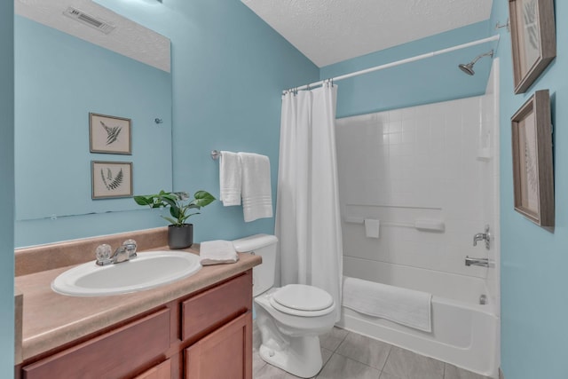 full bathroom with shower / tub combo with curtain, tile patterned floors, vanity, and a textured ceiling