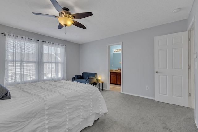 carpeted bedroom featuring connected bathroom, ceiling fan, and a textured ceiling