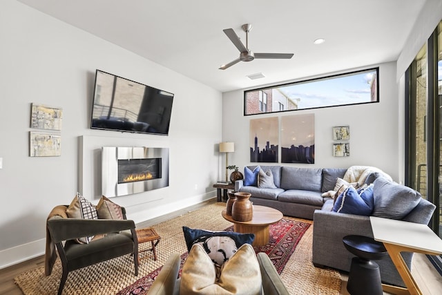 living room with ceiling fan and wood-type flooring