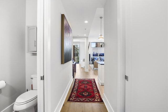 corridor with light hardwood / wood-style floors