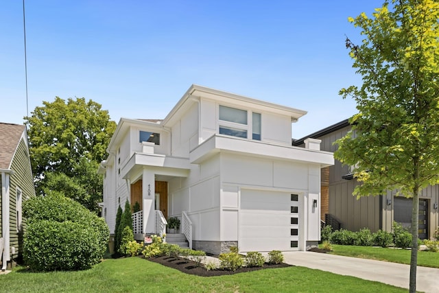 modern home featuring a garage and a front yard