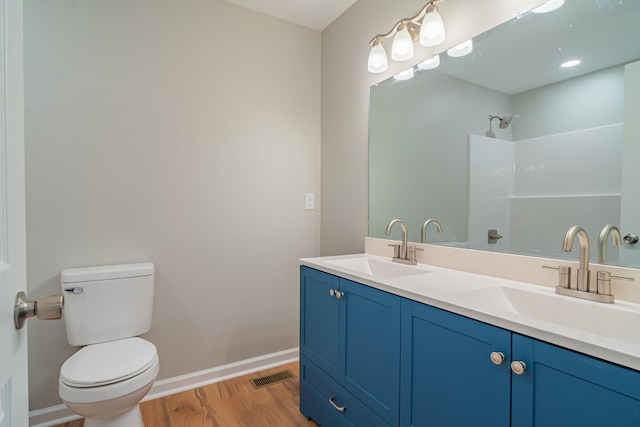 bathroom with vanity, hardwood / wood-style floors, and toilet