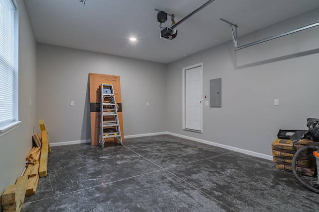 garage with a garage door opener and electric panel