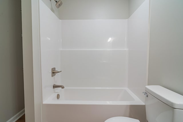 bathroom featuring bathtub / shower combination and toilet