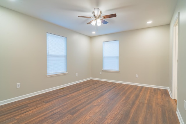 unfurnished room with ceiling fan and dark hardwood / wood-style floors