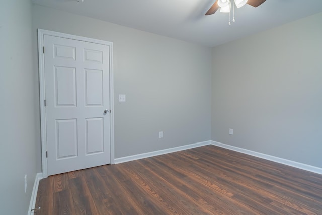 unfurnished room featuring ceiling fan and dark hardwood / wood-style floors