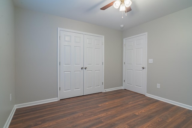 unfurnished bedroom featuring ceiling fan, dark hardwood / wood-style flooring, and a closet