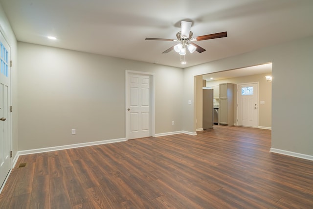 empty room featuring dark wood-type flooring and ceiling fan