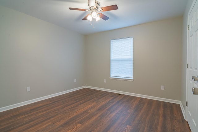 unfurnished room with dark hardwood / wood-style flooring and ceiling fan