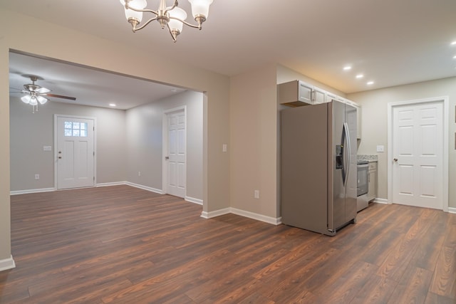 kitchen with stainless steel appliances, dark wood-type flooring, ceiling fan with notable chandelier, and white cabinets