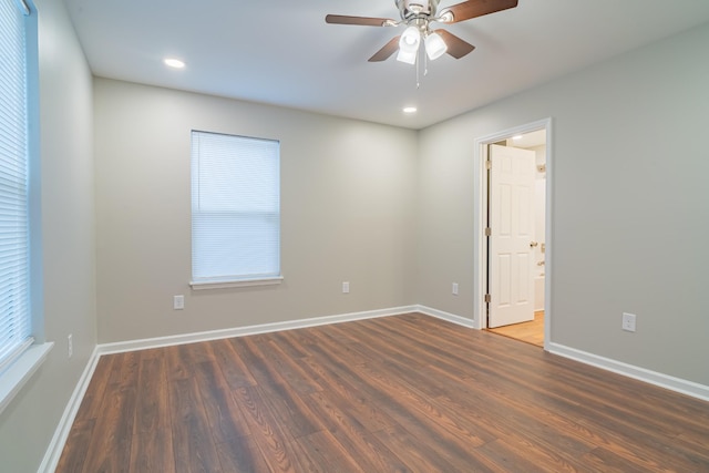 unfurnished room featuring dark hardwood / wood-style floors and ceiling fan