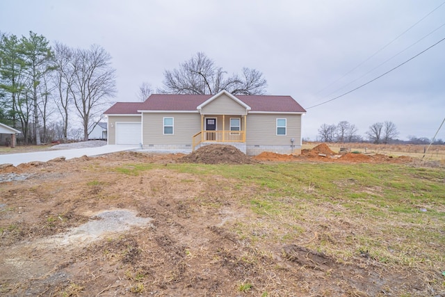 ranch-style house with a garage, covered porch, and a front yard