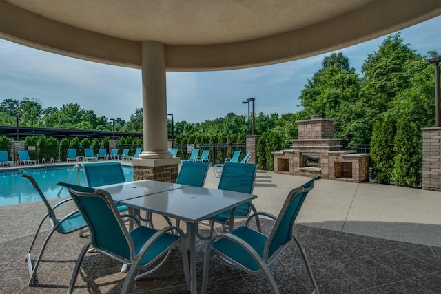 400 Warioto Way Unit 716, Ashland City, TN 37015 - view of patio with an outdoor stone fireplace, a community pool, fence, and outdoor dining space