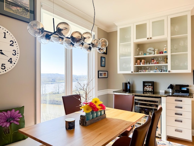 400 Warioto Way Unit 716, Ashland City, TN 37015 - dining space with beverage cooler, ornamental molding, and a bar