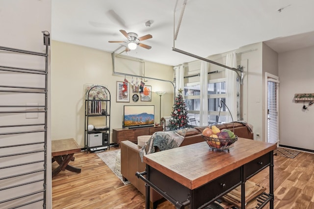 living room featuring ceiling fan and light wood-type flooring