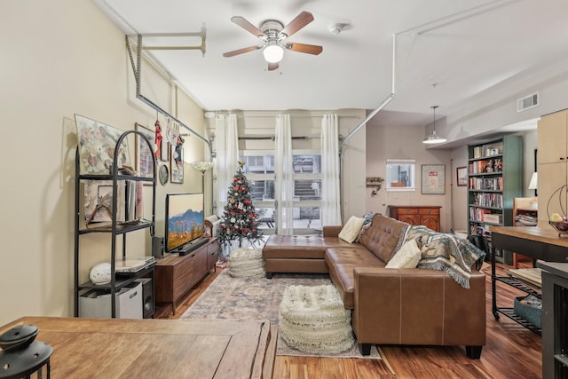 living room with hardwood / wood-style flooring and ceiling fan