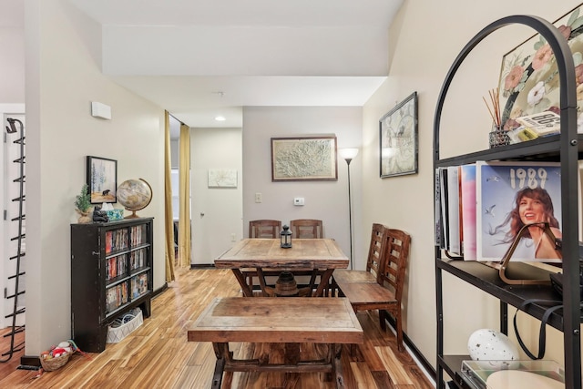 dining space with hardwood / wood-style flooring