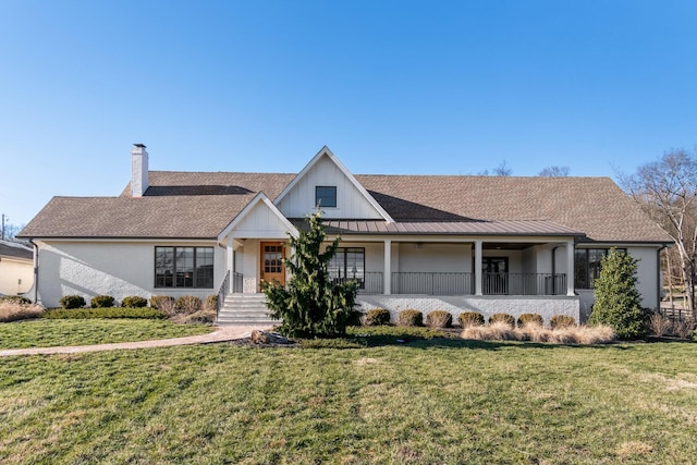 view of front of house with covered porch and a front yard