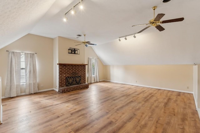 unfurnished living room with ceiling fan, light hardwood / wood-style floors, and vaulted ceiling