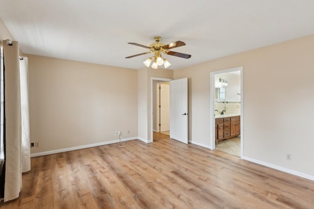 unfurnished bedroom featuring ceiling fan, ensuite bath, and light hardwood / wood-style floors