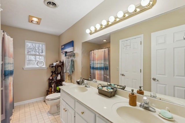 bathroom featuring vanity, tile patterned floors, and toilet