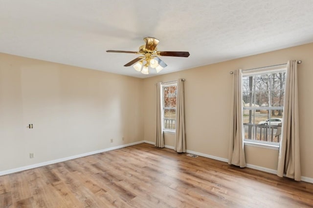 empty room with ceiling fan and light wood-type flooring