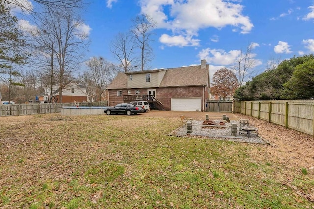 view of yard featuring a fenced in pool and an outdoor fire pit