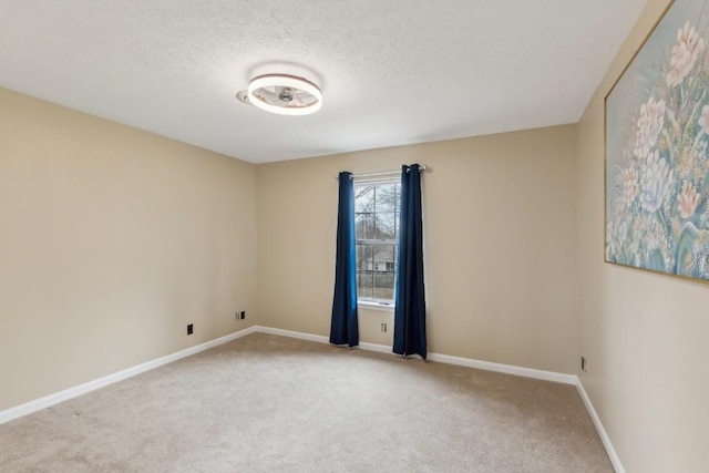 carpeted empty room with a textured ceiling