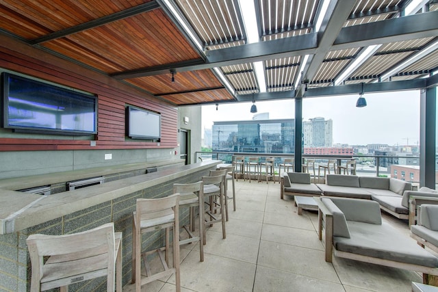 view of patio with outdoor lounge area and exterior bar