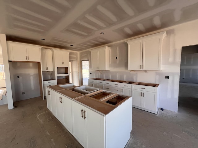 kitchen with white cabinetry and a center island