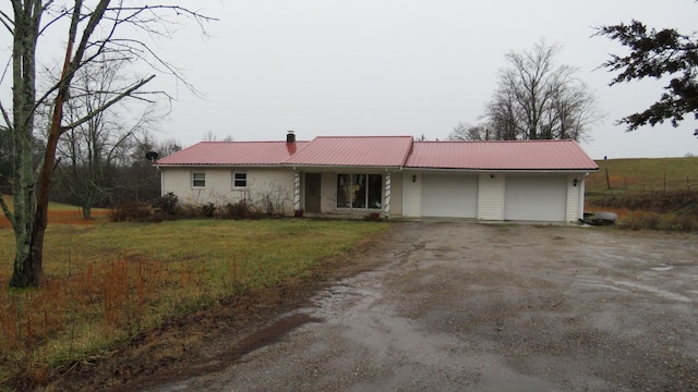 ranch-style home with a garage and a front yard