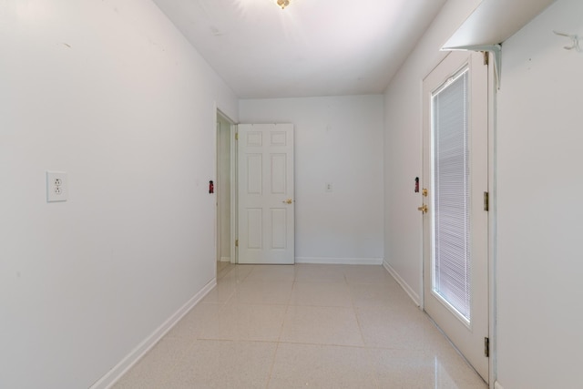 corridor featuring light tile patterned flooring