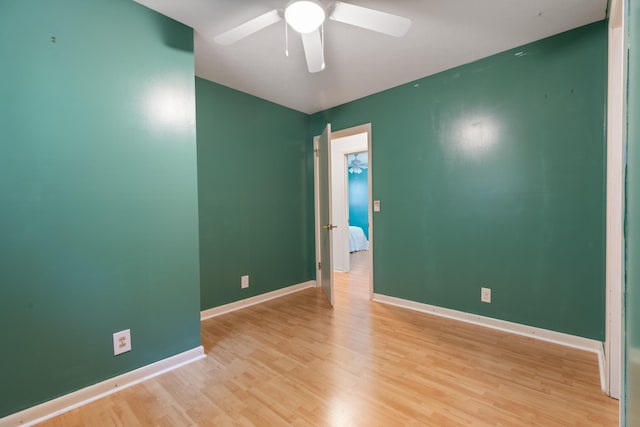 spare room with ceiling fan and light wood-type flooring