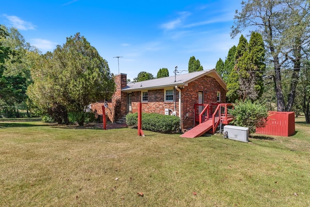 rear view of property with a lawn