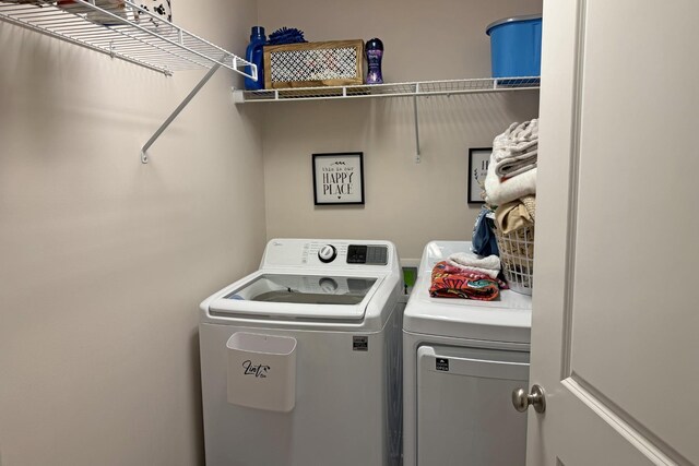 clothes washing area featuring separate washer and dryer