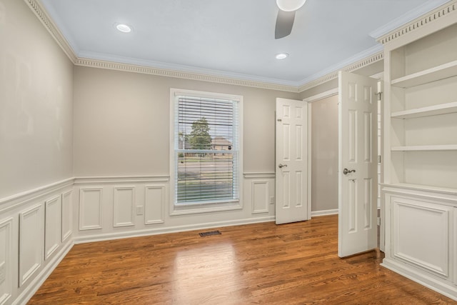 spare room featuring crown molding, ceiling fan, and hardwood / wood-style floors